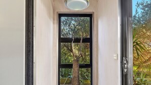 Eine Tür mit Blick auf Bäume durch ein Fenster.