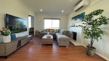 Family House | Living area | 65-inch TV with cable channels