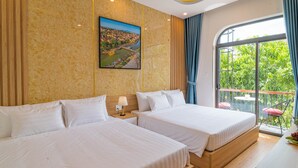 A hotel room with two beds, a painting of a cityscape, a balcony with a view of greenery, and a window with curtains. - Mint Hoi An Villa (Da Nang)