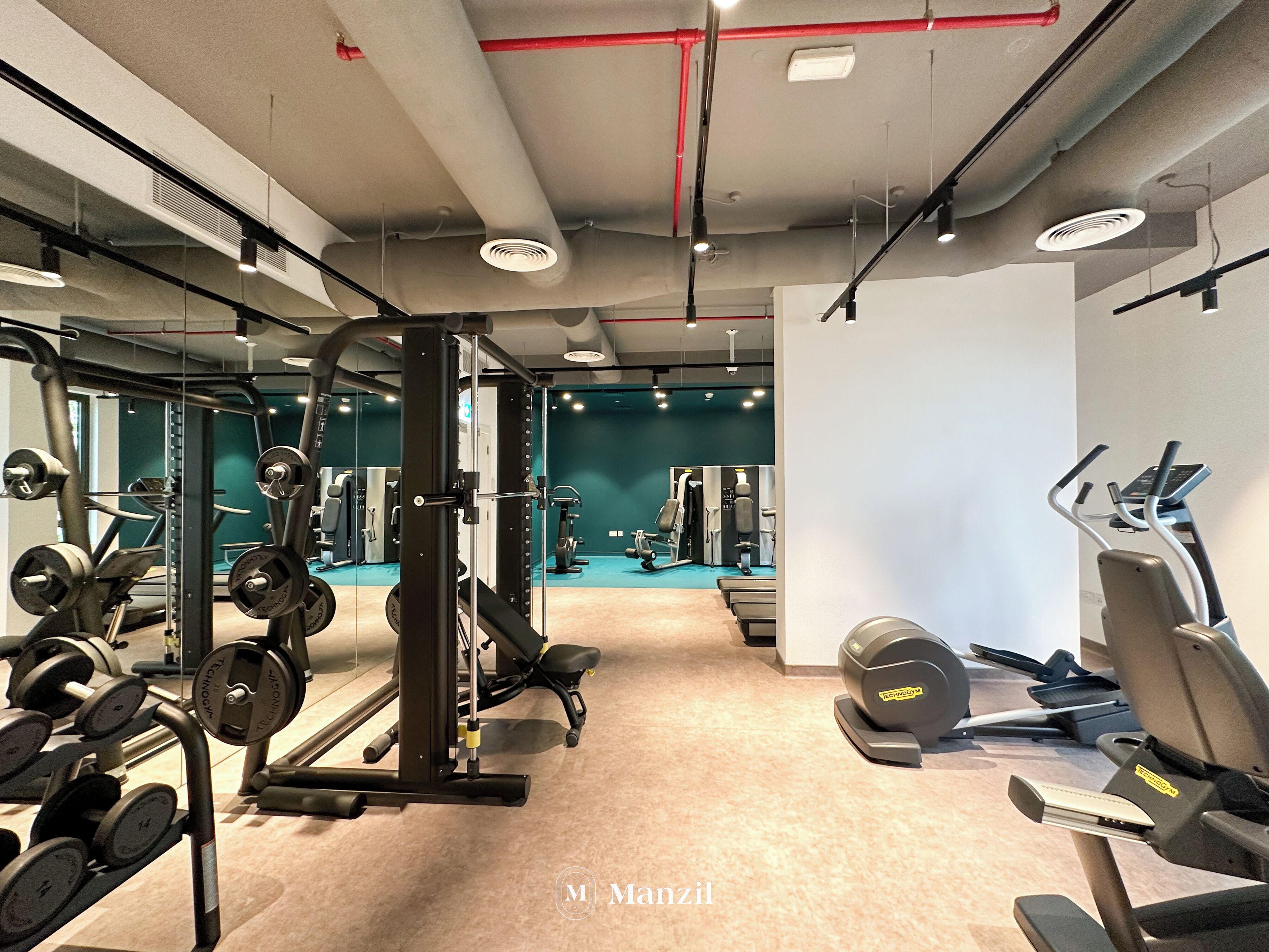 A gym with weightlifting equipment, treadmills, and exercise machines.