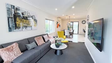 Family House | Living area | 65-inch TV with cable channels