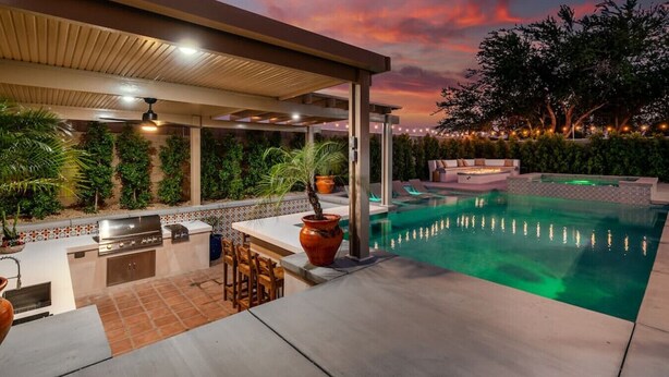 An outdoor pool area with a covered patio, bar, and grill. - Hacienda San Miguel | Resort Style Pool W/ Sunken Outdoor Kitchen (Indio)