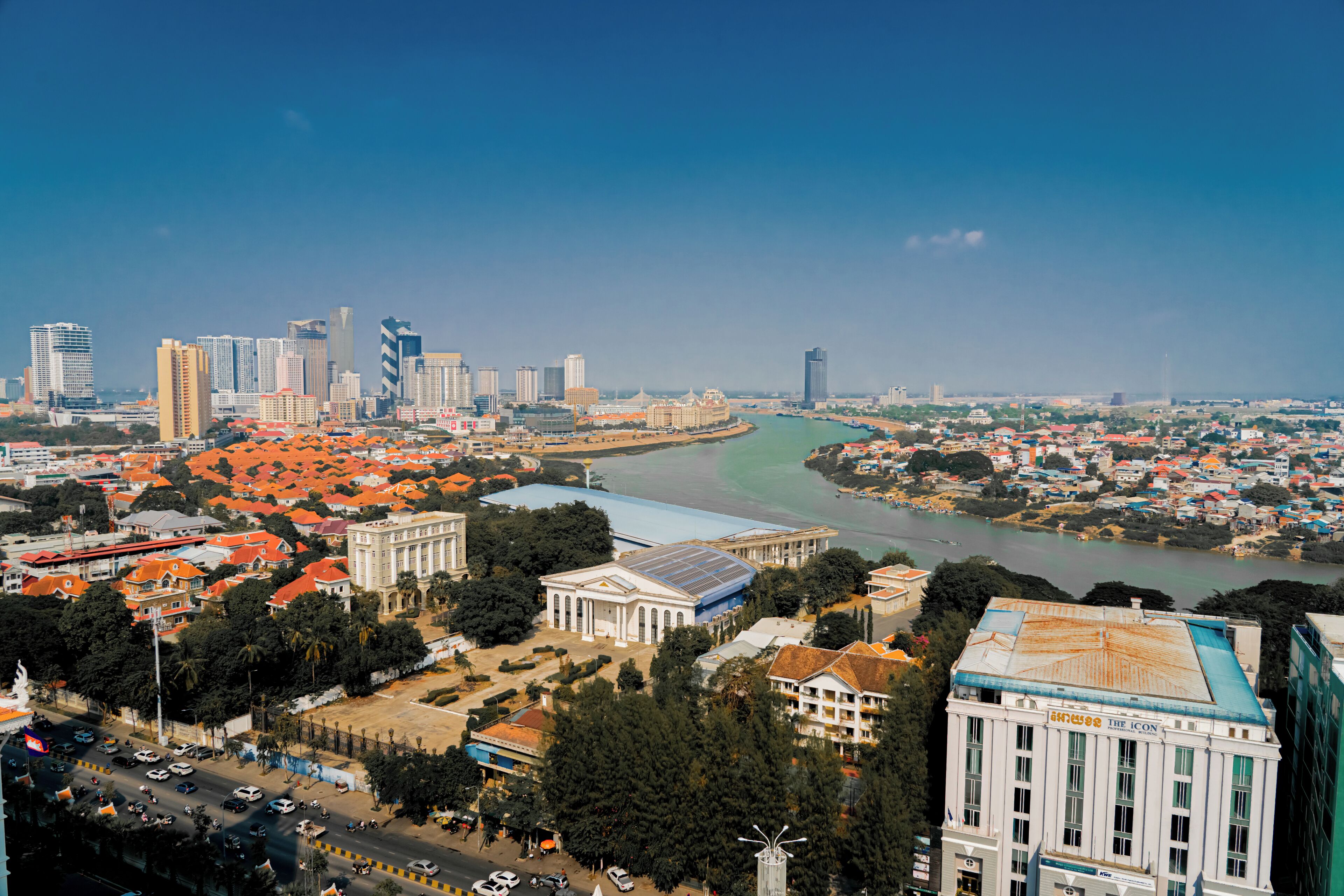 A cityscape with a river, buildings, and a prominent white building with columns.