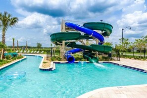 A water park with multiple slides and a swimming pool.