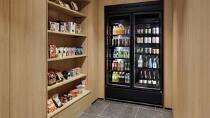 A storage area with shelves stocked with snacks, beverages, and condiments. - Fairfield By Marriott Kumamoto Aso (Aso)