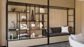 A modern interior with a built-in bookshelf, a cushioned seating area, and a small table.