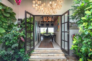 Step into a warm and inviting space, where lush greenery and soft lighting set the tone for a relaxing stay.