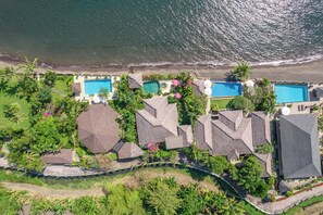 Guests can enjoy scenic views of the beach and lush surroundings from multiple pools.