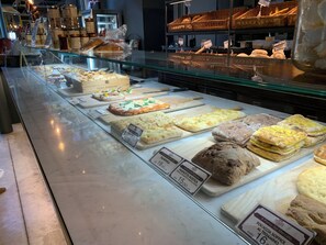 A bakery display case with various types of bread and pastries, including focaccia, and price tags visible. - BELLAVISTA, bright and stylish two bedroom apartment in the heart of Ravenna (Ravenna)