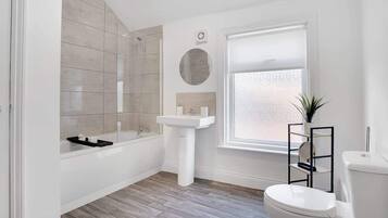 Bathtub, hair dryer, shampoo