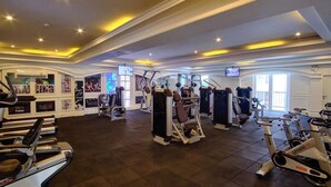 A spacious gym with various exercise equipment, including treadmills and weight machines, and motivational posters on the walls. - Seven Seas Côte d'Azur by PSR (Sattahip)