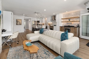A modern kitchen with white cabinets, a wooden countertop, and a built-in oven. - Fairway Haven - Luxury Carlsbad Golf Course Condo on the Omni La Costa Resort (Carlsbad)