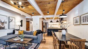 Una sala de estar moderna con un sofá, una mesa de centro y un comedor con sillas y una mesa.