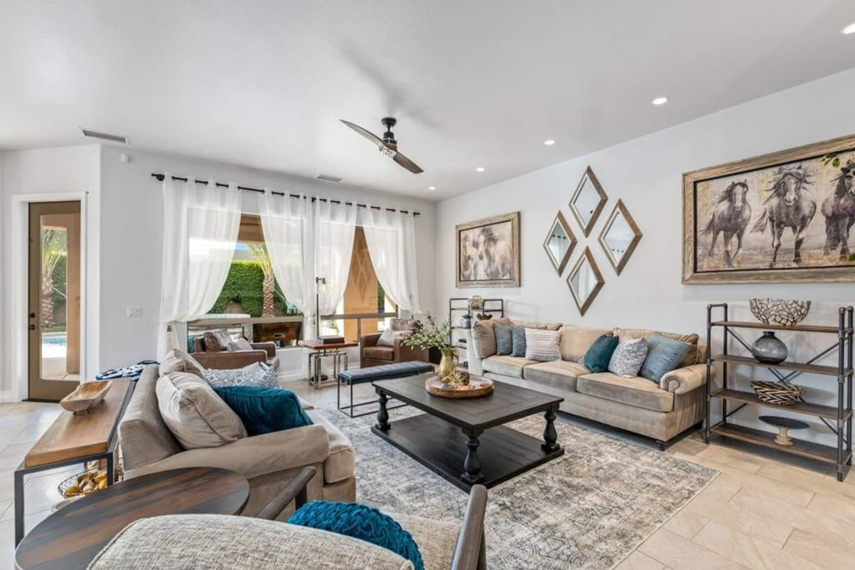 A spacious living room with a sofa set, a coffee table, and a bookshelf.