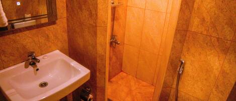 A bathroom with a sink, toilet, and shower.