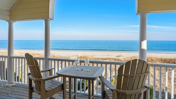A covered outdoor area with a view of the beach and ocean. - Marlin View: Oceanfront w/ Pool, Walk to Dining (Garden City)