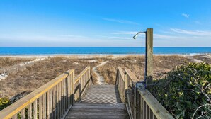 A wooden boardwalk leading to a beach with a clear view of the ocean. - Marlin View: Oceanfront w/ Pool, Walk to Dining (Garden City)