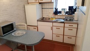 A compact kitchen with a microwave, a sink, and a stove.