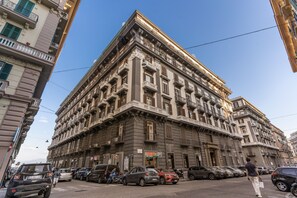 A multi-story building with a classic architectural style, featuring balconies and a ground-level entrance. - La Corte di Partenope (Naples)