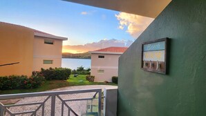 A view of a building with a sign reading "Beach HOUSE" and a glimpse of a green landscape and a body of water in the background. - Private Ocean Front Via Maris Villa with Big Pool @ Culebra, Recently Refreshed! (Culebra)