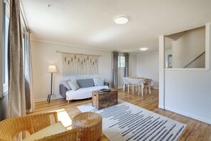 Relax in this inviting living space with a sofa set, coffee table, and woven side table.