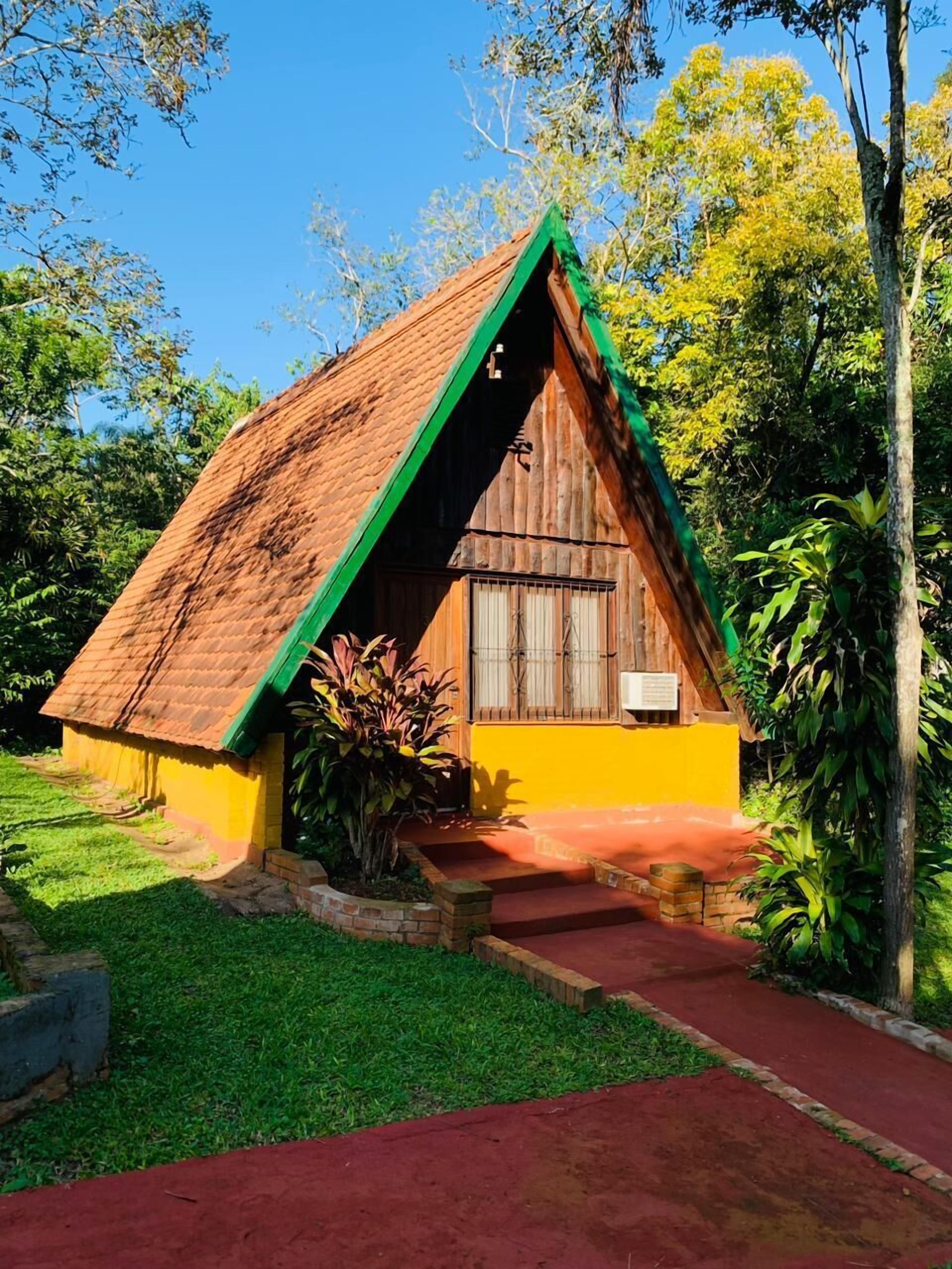 A small, single-story building with a sloped roof and a green trim.