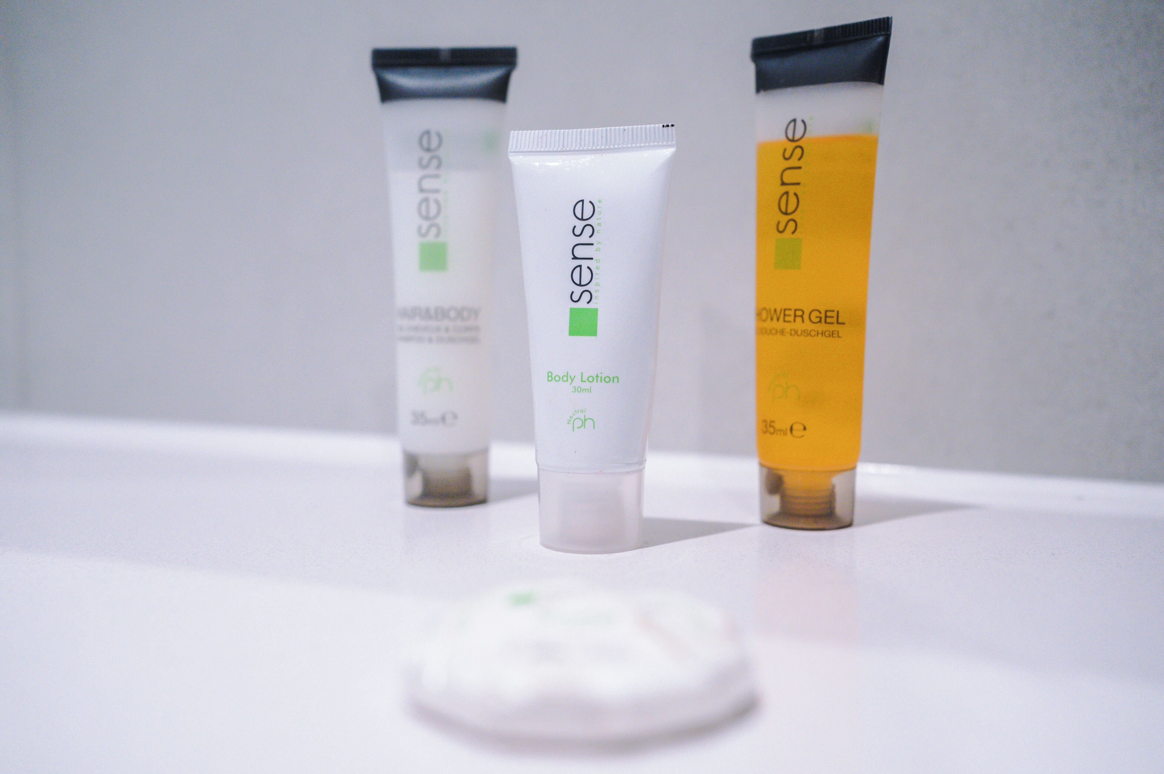 Three skincare products on a white surface.