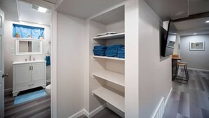 A modern bathroom with a white vanity, a blue towel, and a shower area. - Strawberry Peaks Ogden 6 guests (Ogden)