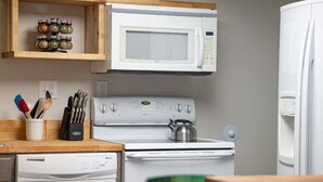A compact kitchen with a microwave, stove, and dishwasher. - Strawberry Peaks Ogden 6 guests (Ogden)