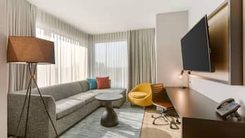 Premium bedding, desk, laptop workspace, blackout drapes