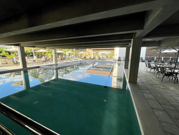 Outdoor pool, pool umbrellas, lifeguards on site