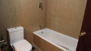 A bathroom with a toilet, a bathtub, and a shower. - Neydo Hotel Buddhist Monastery (Dakshinkali)