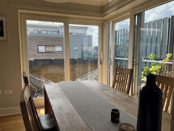 Enjoy a meal on the balcony with a view of the surrounding greenery.