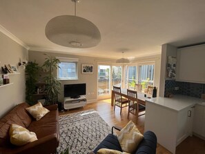 Relax in this inviting space with a leather sofa, flat-screen TV, and dining area.