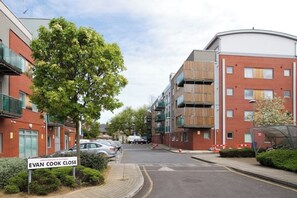 Stroll along Evan Cook Close, surrounded by contemporary apartment buildings with balconies and large windows.