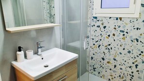 Shower, hair dryer, slippers, towels