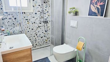 Shower, hair dryer, slippers, towels