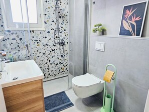 Shower, hair dryer, slippers, towels