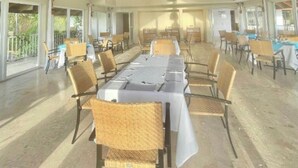 A spacious indoor dining area with high ceilings and natural light. - Wake Up At Paradise (Santa Barbara Samana)