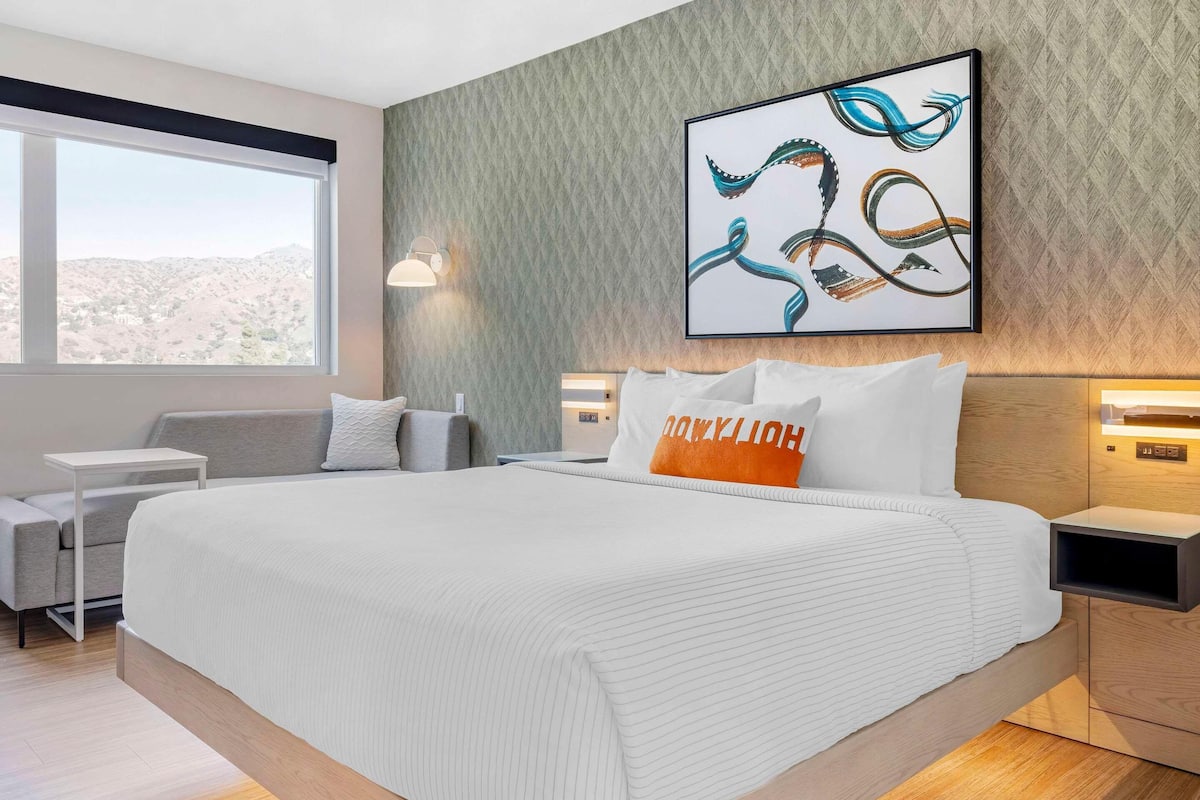Premium bedding, desk, laptop workspace, blackout curtains