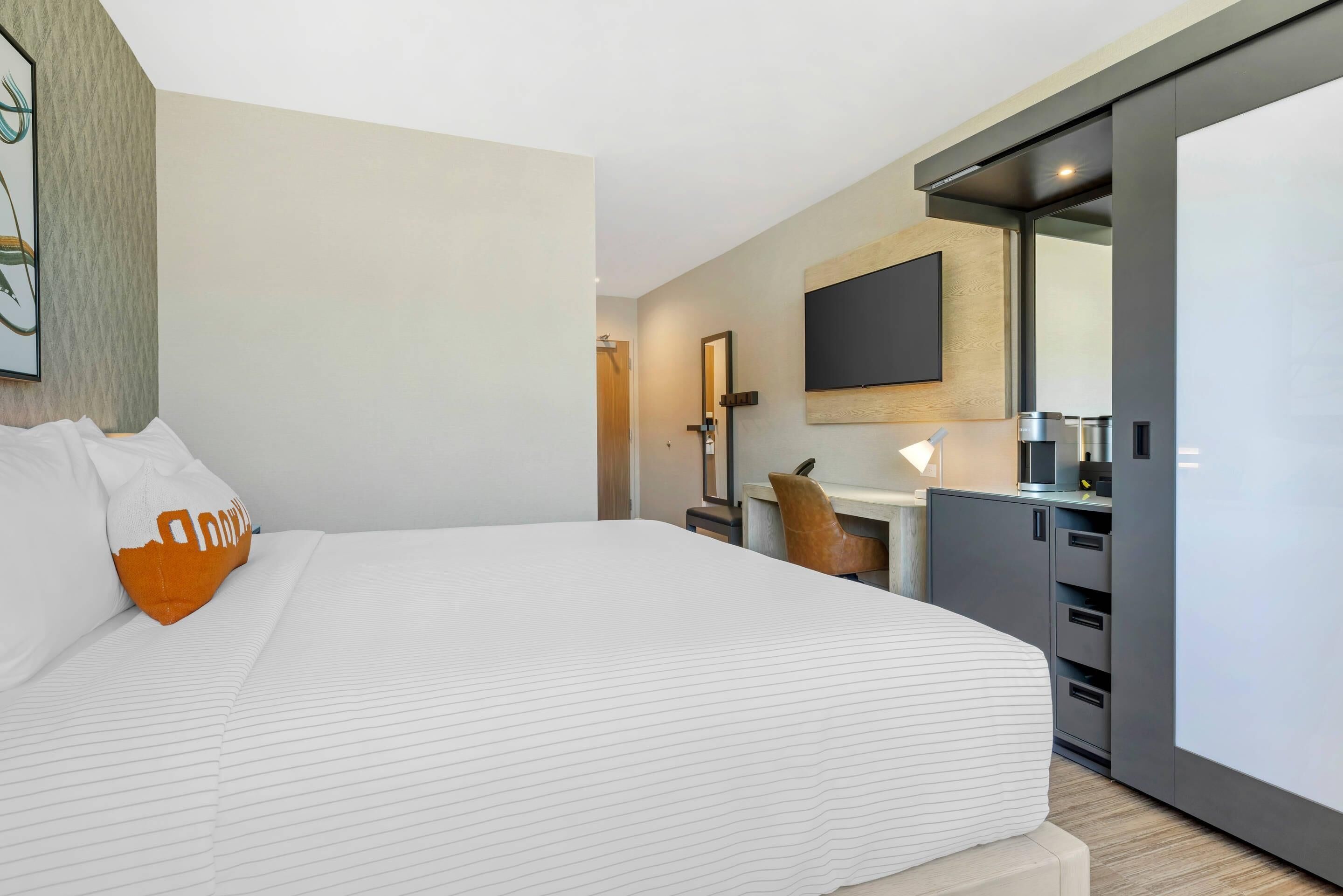 Premium bedding, desk, laptop workspace, blackout drapes