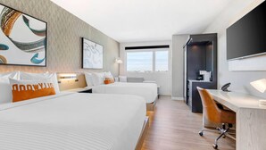 A modern hotel room with two beds, a desk, and a large window. - Cambria Hotel Burbank Airport (Burbank)