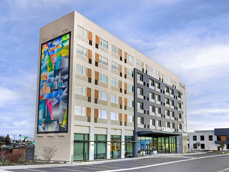A multi-story hotel with a modern facade, large windows, and a prominent entrance.
