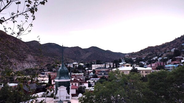 A town with a prominent green-domed building in the center, surrounded by residential houses and hills in the background. - Central Location and Spectacular Views - Unit 2! (Bisbee)