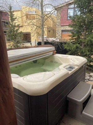 Relax in a hot tub with multiple seating areas and a control panel.