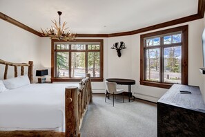 Enjoy a comfortable stay in this well-appointed room with a large bed, desk, and chandelier.