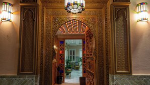 An ornate entrance with intricate carvings and a chandelier. - Hotel Riad Chami (Marrakech)