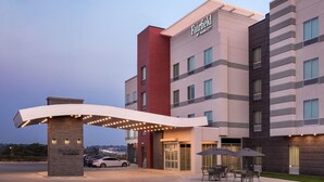 A Fairfield by Marriott hotel with a modern design, featuring a prominent entrance, outdoor seating area, and a parking lot. - Fairfield by Marriott Inn & Suites Omaha at MH Landing (Omaha)