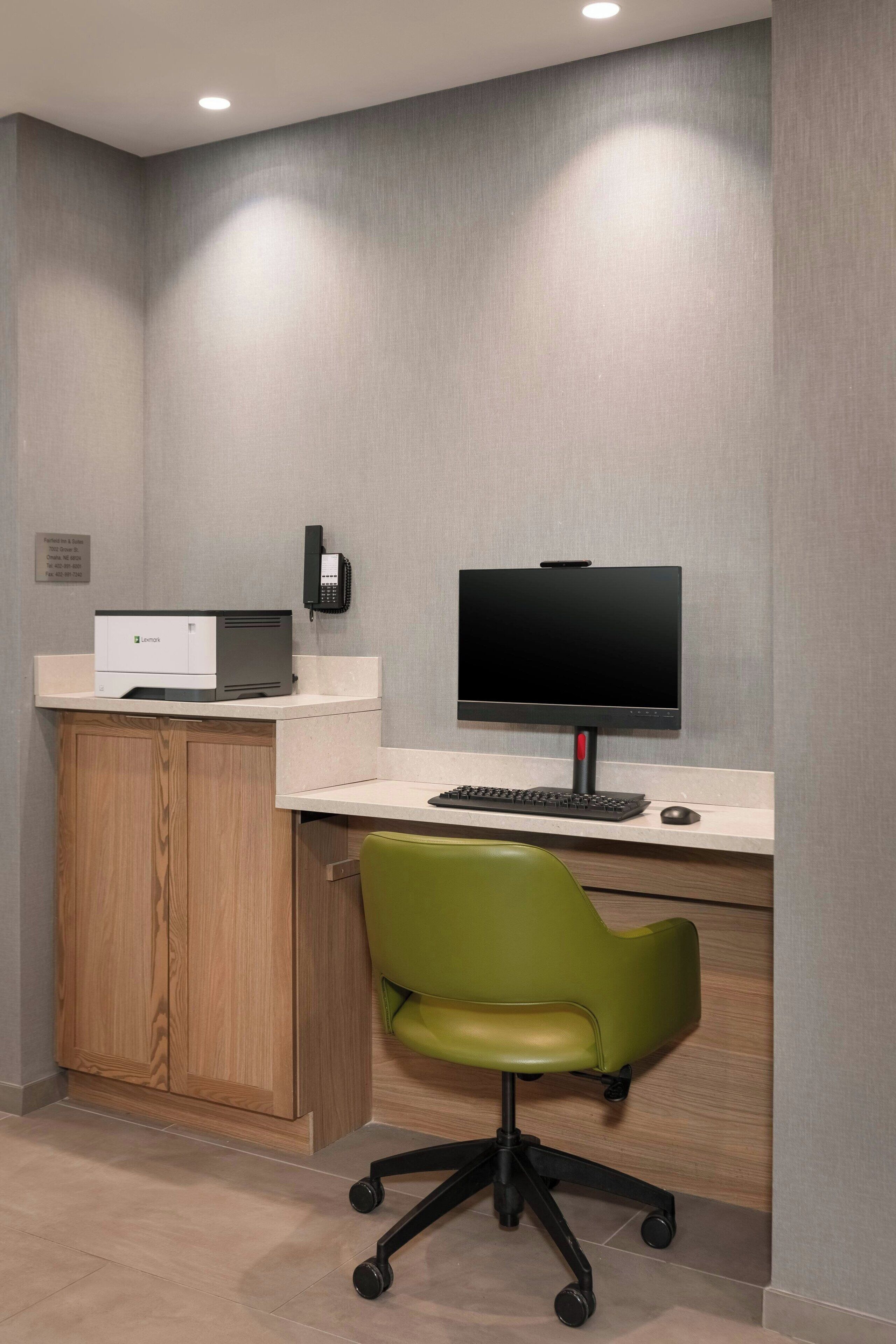 A modern office space with a desk, computer, and office chair.