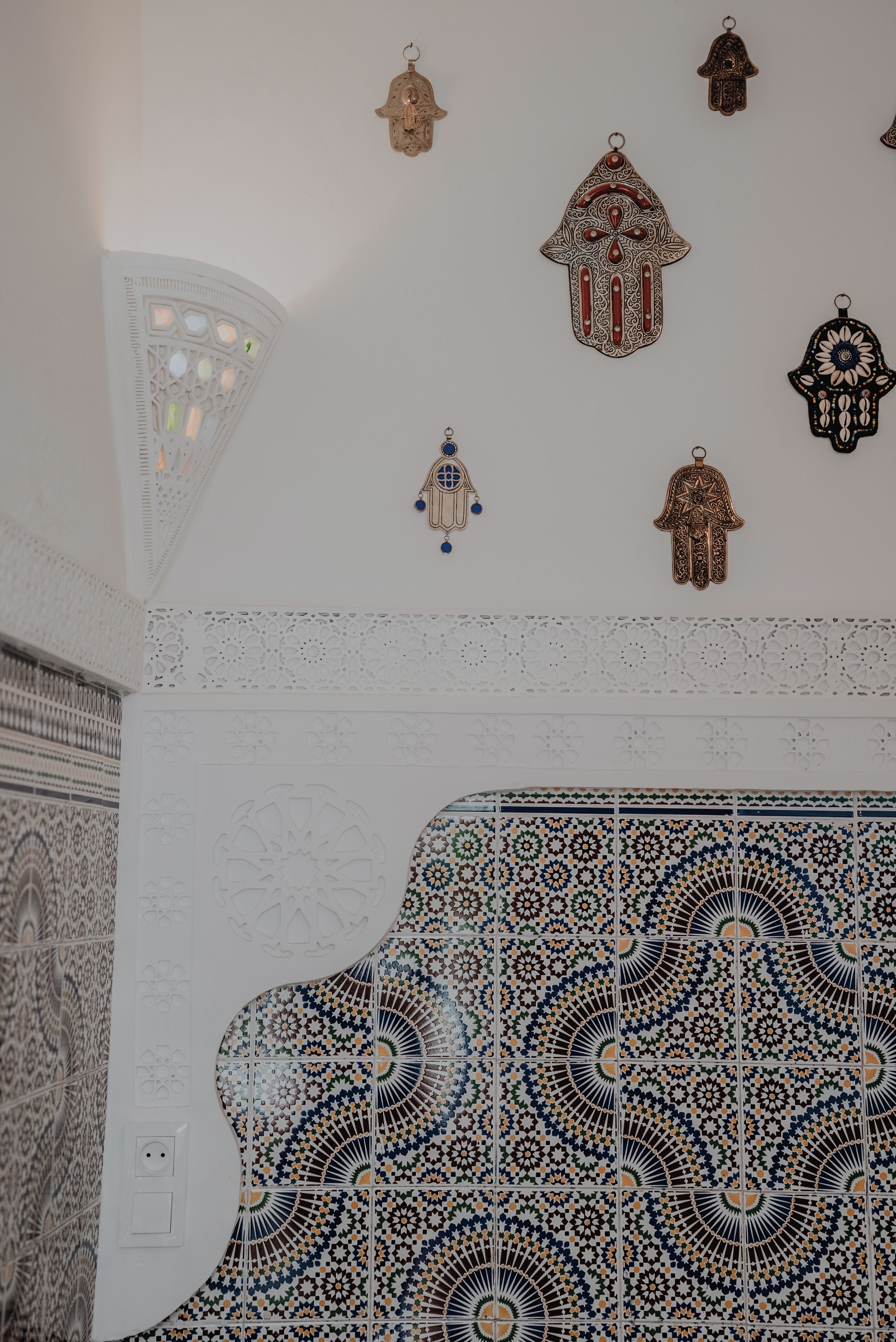 A room with intricate tile patterns and hanging decorative elements.